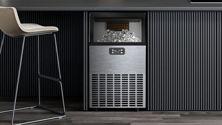 A sleek stainless steel ice maker filled with fresh ice cubes installed beneath a modern kitchen counter.