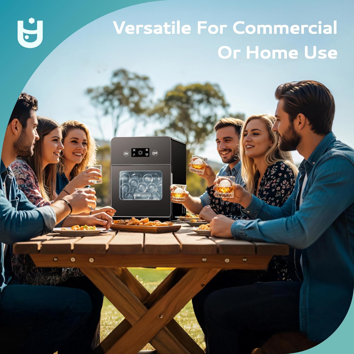 Black Euhomy Rock SE Sphere Ice Maker on picnic table with people enjoying drinks, versatile for home or commercial use.